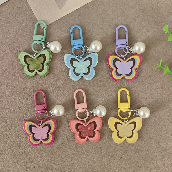 Colorful butterfly keychain with faux pearls, a chic bag charm accessory for women.