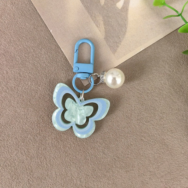 Gift-ready elegant butterfly pearl keychain, a charming women's accessory for keys or bags.