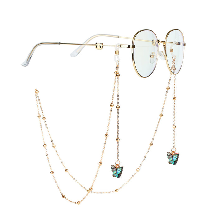 Elegant women's glasses chain with golden butterfly accents, fashionable eyewear holder.
