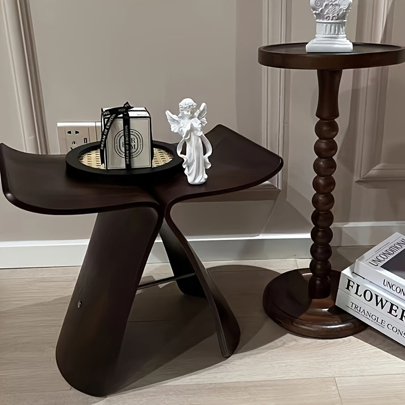 Elegant butterfly wood stool, complementing a modern living room interior. Chic accent furniture.