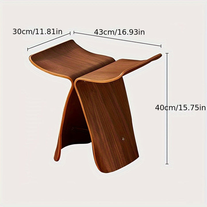 Elegant solid wood butterfly stool with sleek, modern design. A sophisticated accent piece.