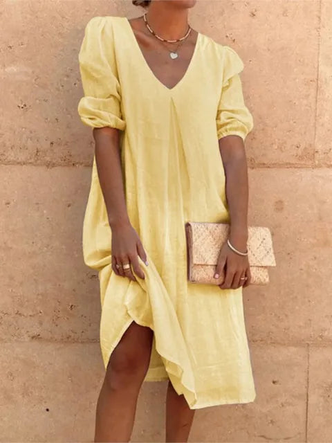 Elegant casual women's midi dress for summer. Features a v-neck, bubble sleeves, and relaxed, flowy fit. Perfect for vacation.