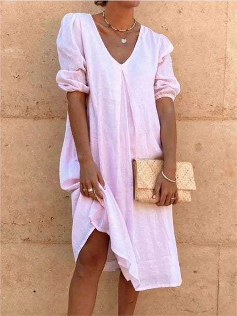 Comfortable, relaxed fit midi dress for women. This elegant casual summer dress features a v-neck and bubble sleeves for chic style.