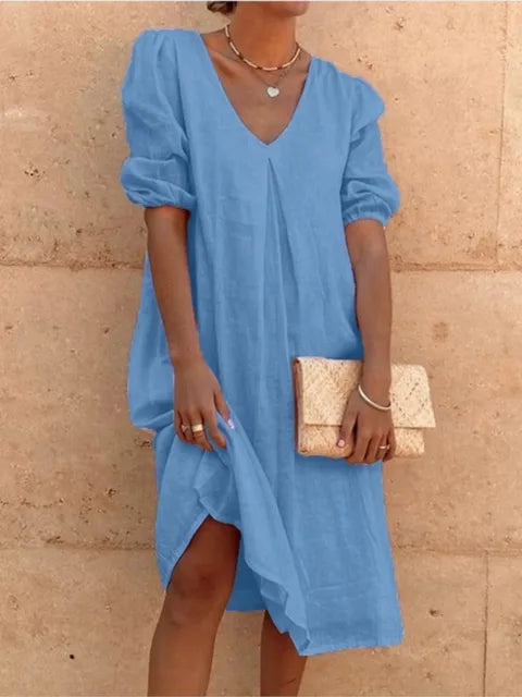 Fashionable women's midi dress blending elegant style with casual comfort. A v-neck, bubble sleeve summer dress for chic looks.