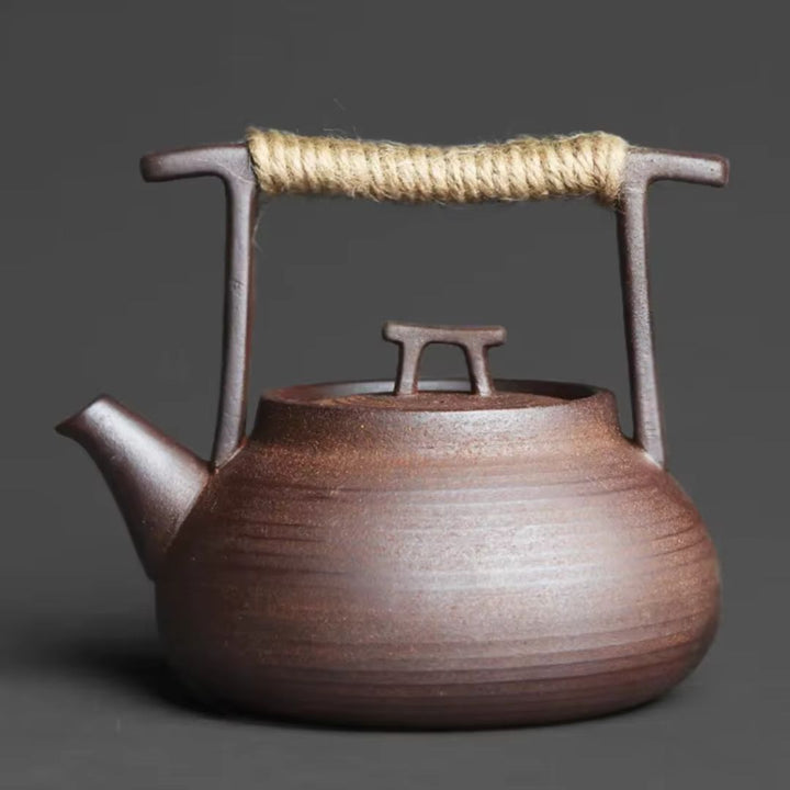 Elegant ceramic teapot with a matching tea warmer, perfect for keeping hot tea cozy at home.