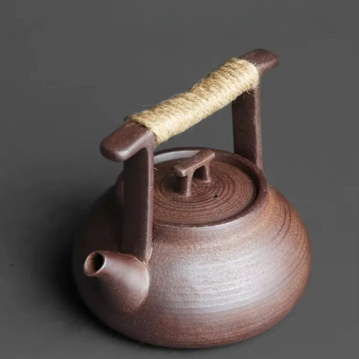 Top-down view of a ceramic teapot & tea warmer setup, ready for relaxing hot tea at home.