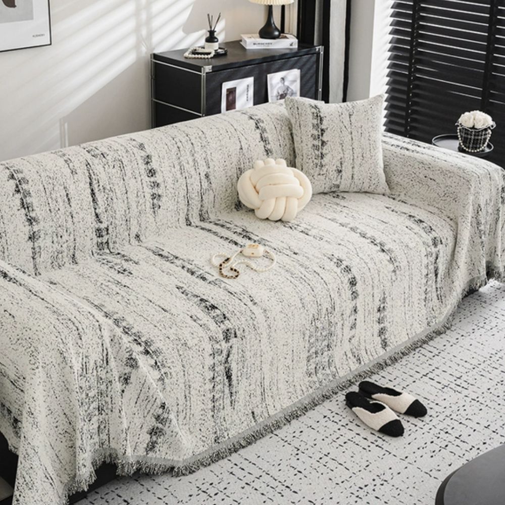 Elegant chenille sofa cover protecting a living room couch, adding comfort & style.
