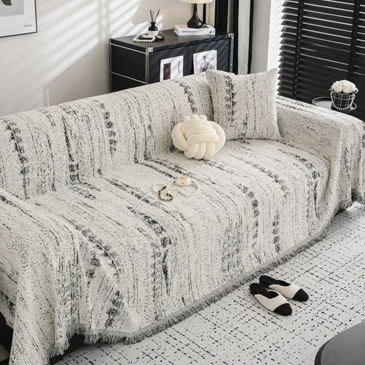 Elegant chenille sofa cover protecting a living room couch, adding comfort & style.