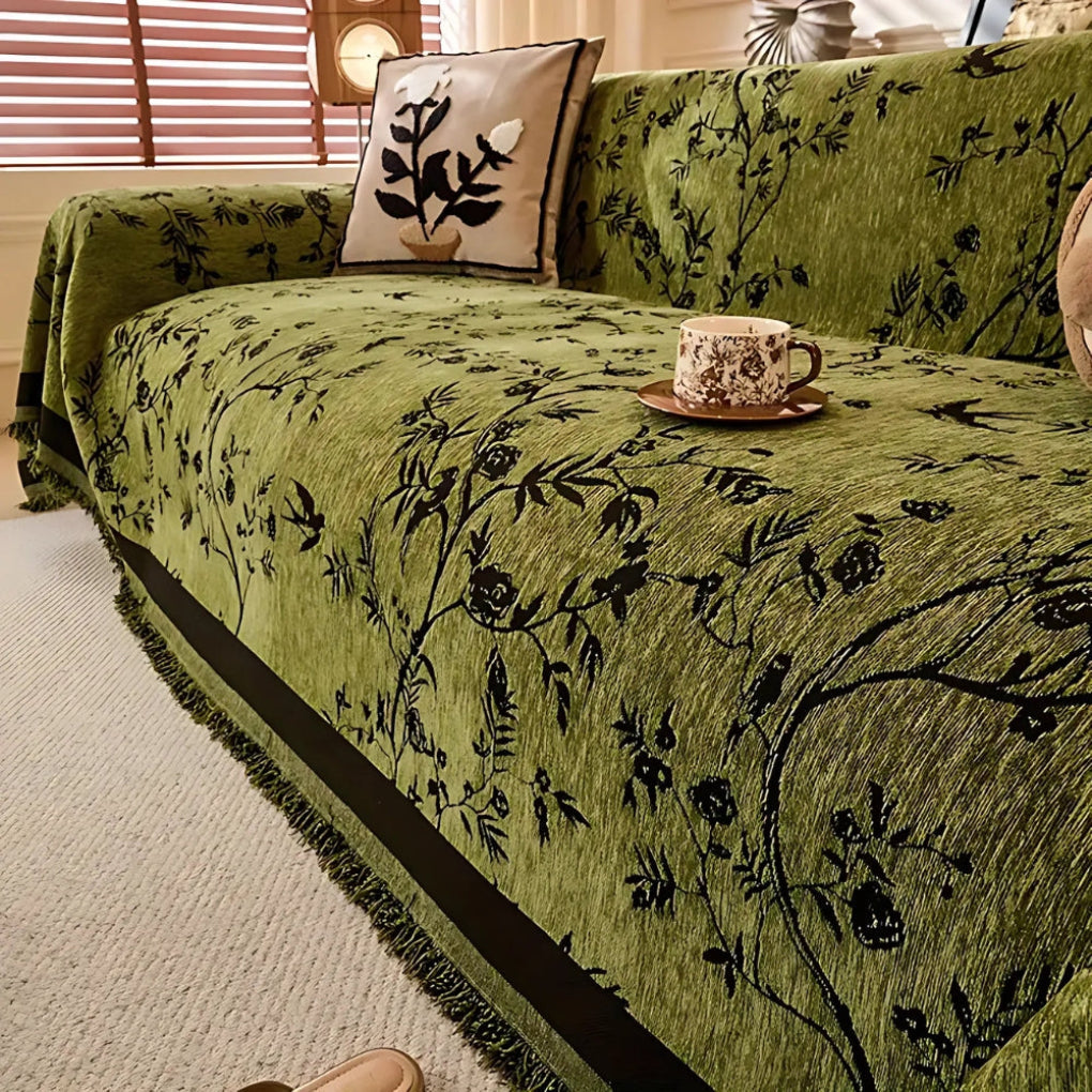 Elegant chenille throw blanket with a detailed floral pattern and fringe trim, perfect for luxury home decor.