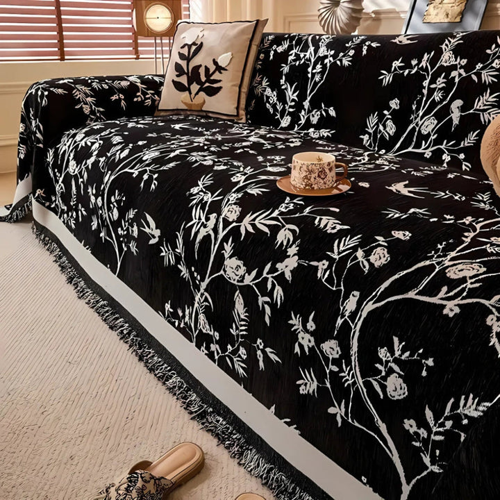 Luxurious floral chenille throw with decorative fringe trim, enhancing bedroom or living room decor.