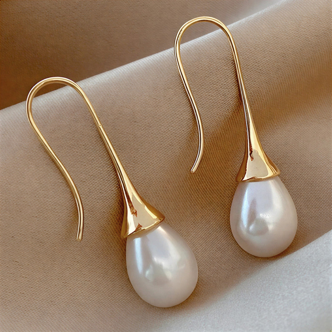 Elegant classic pearl drop earrings for women, featuring timeless pearls. Perfect for a sophisticated look or special gift.