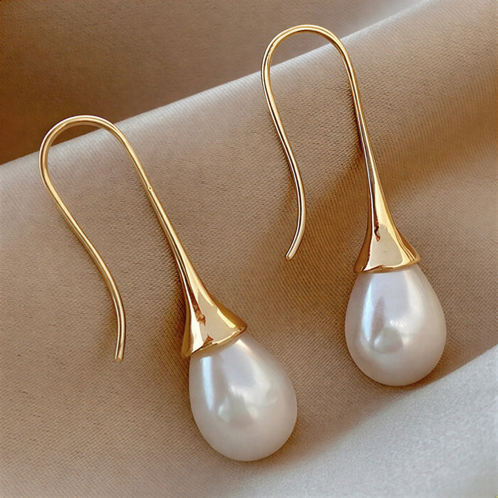 Elegant classic pearl drop earrings for women, featuring timeless pearls. Perfect for a sophisticated look or special gift.