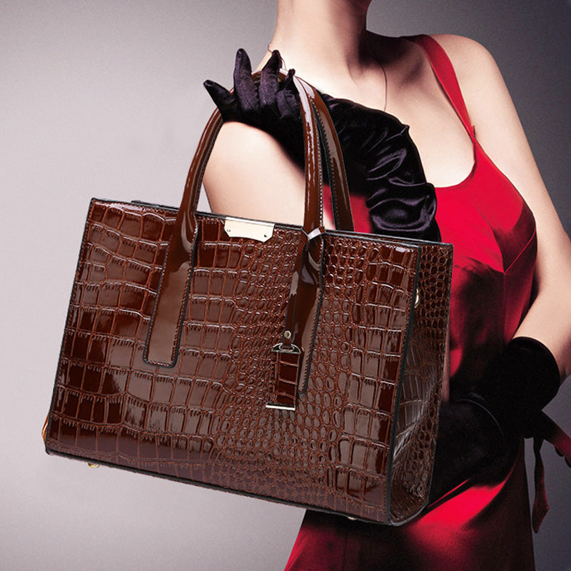 Detailed shot of PU leather crocodile embossed texture on a women's luxury handbag.
