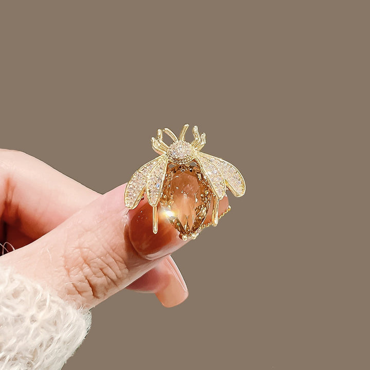 Elegant crystal bee brooch with sparkling accents, a women's fashion lapel pin.