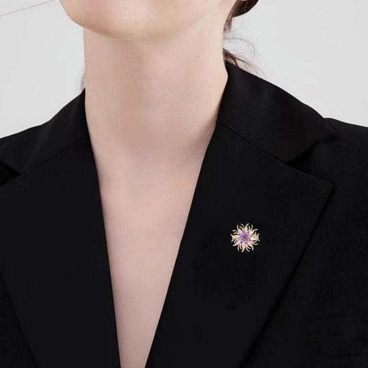 Sparkling crystal sunburst brooch, elegant women's fashion jewelry, versatile accessory.