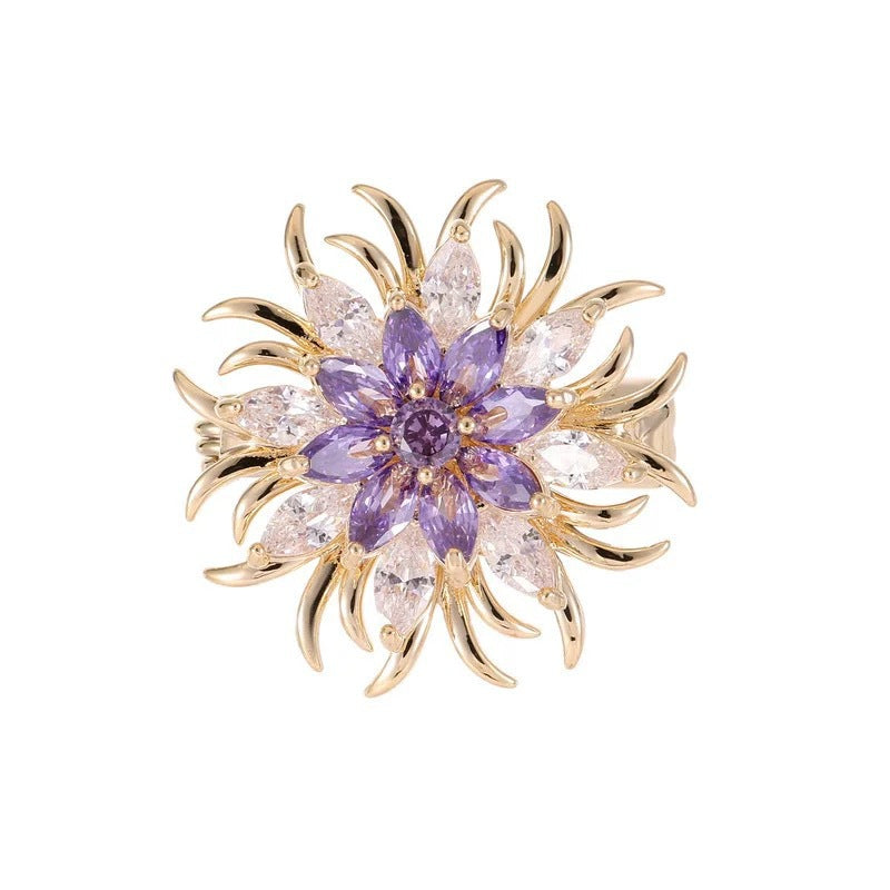 Women's sparkling crystal sun motif brooch, gold-tone metal, elegant fashion pin for dresses.
