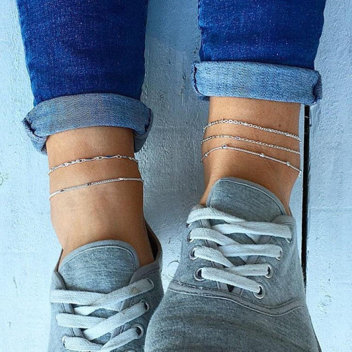 Stylish white dainty chain anklet, adjustable foot jewelry for women. Elegant and delicate design.