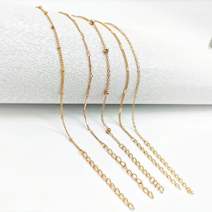 Adjustable dainty chain anklet, elegant women's foot jewelry. Versatile gold or white design for everyday wear.
