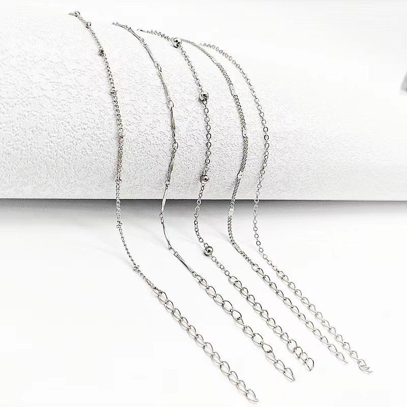 Delicate women's foot jewelry: an elegant dainty chain anklet. Adjustable design, available in gold & white tones.