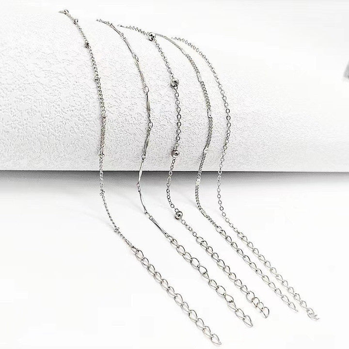 Delicate women's foot jewelry: an elegant dainty chain anklet. Adjustable design, available in gold & white tones.