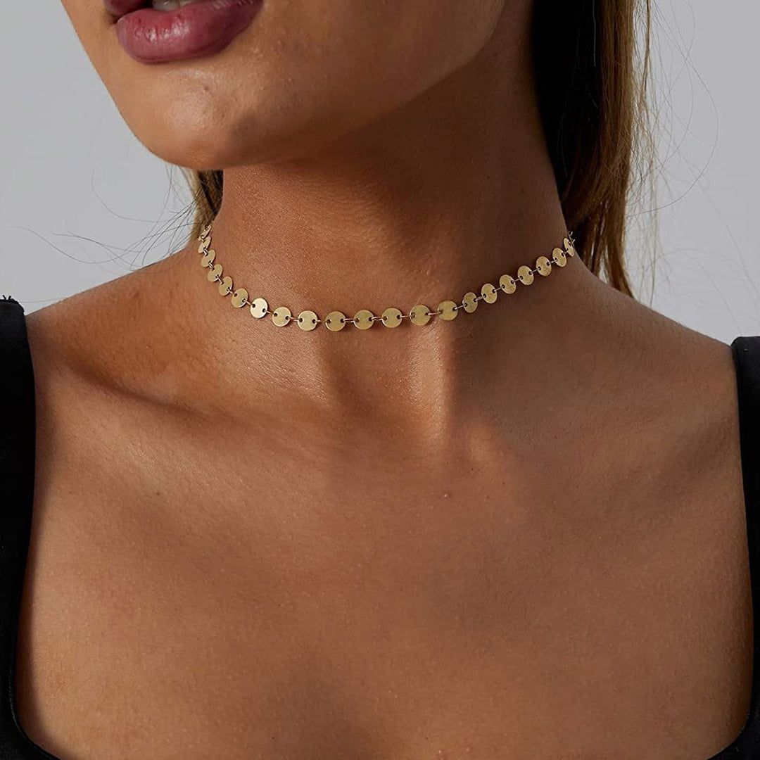 Tiny heart pendant on an elegant gold choker necklace, a sweet and dainty women's jewelry gift.