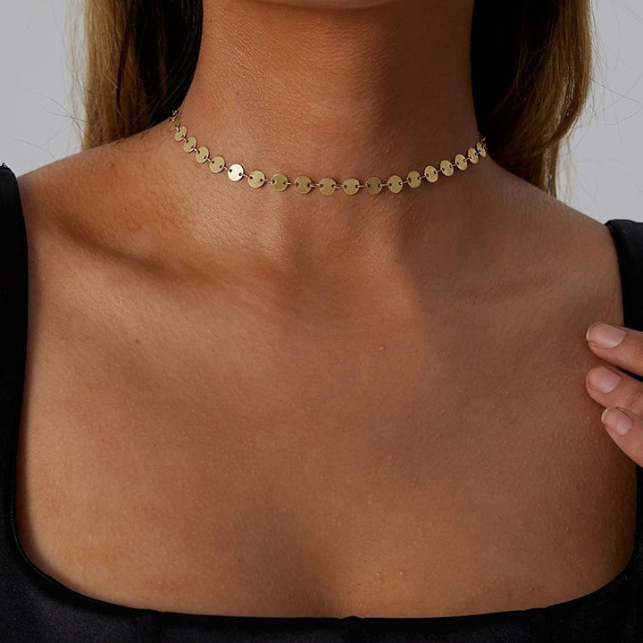 Close-up of a delicate gold chain choker necklace, highlighting its elegant dainty design and fine detail.