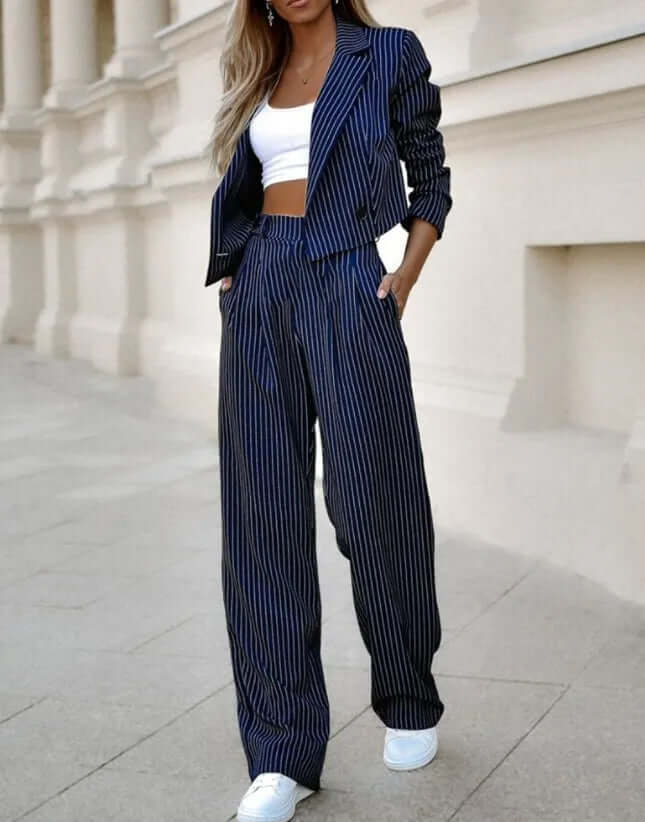 Elegant dark blue women's two-piece set, tailored jacket and trousers. Ideal for formal wear or smart casual.