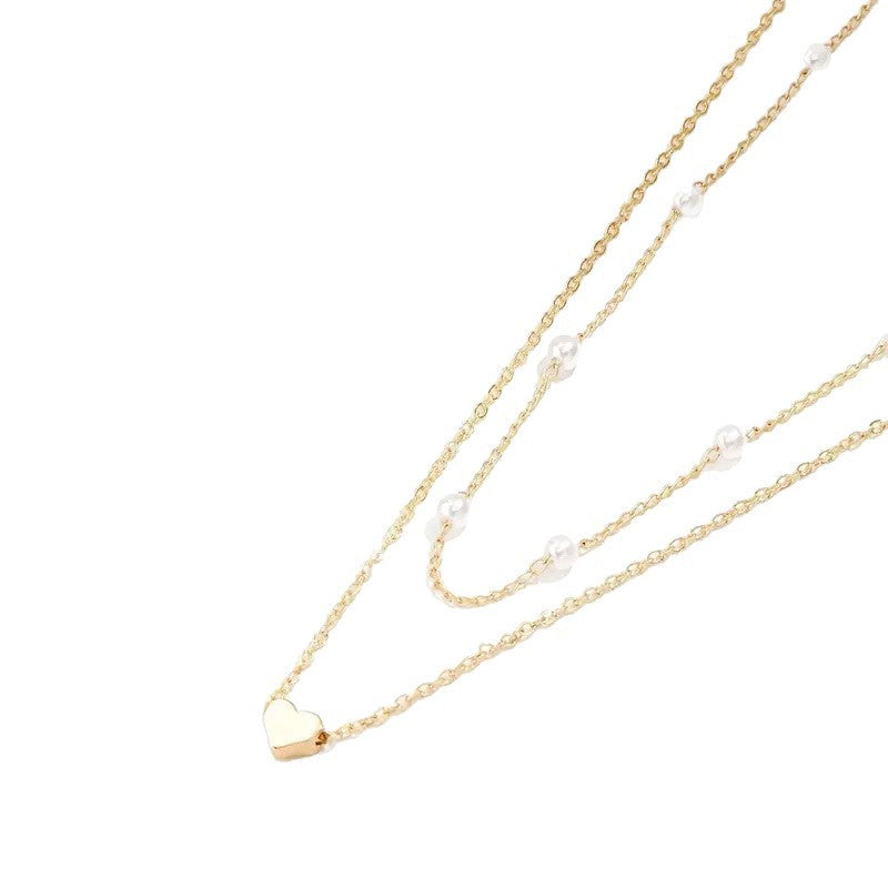 Close-up of a graceful double-layered pearl necklace. Elegant women's delicate jewelry.