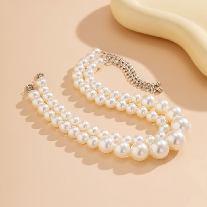 Close-up of a classic double strand pearl necklace, highlighting the exquisite women's fashion accessory.
