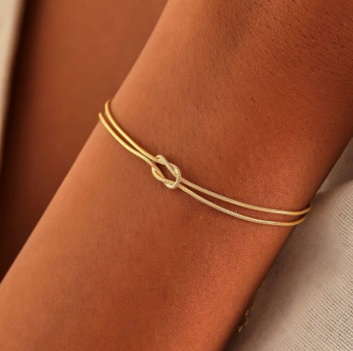 Close-up of a sophisticated dual-strand knot bracelet, showcasing its unique design.