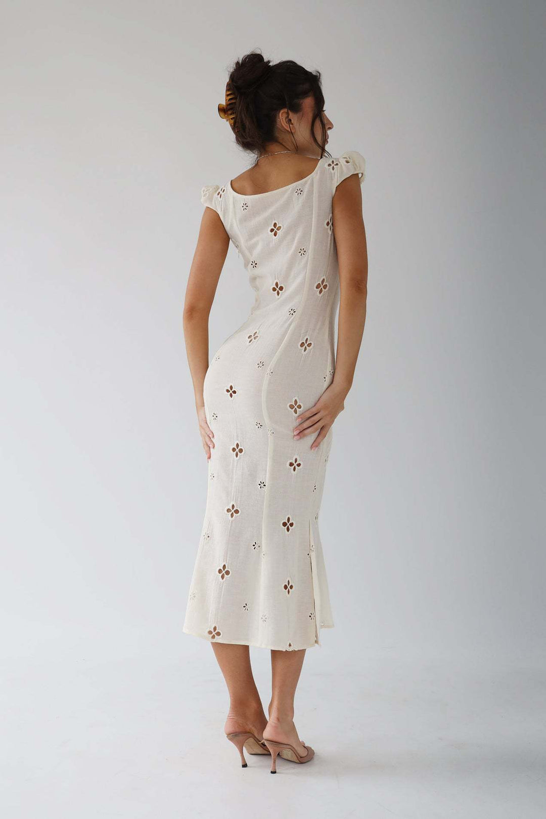 Full-length view of a women's elegant embroidered mermaid wedding dress.