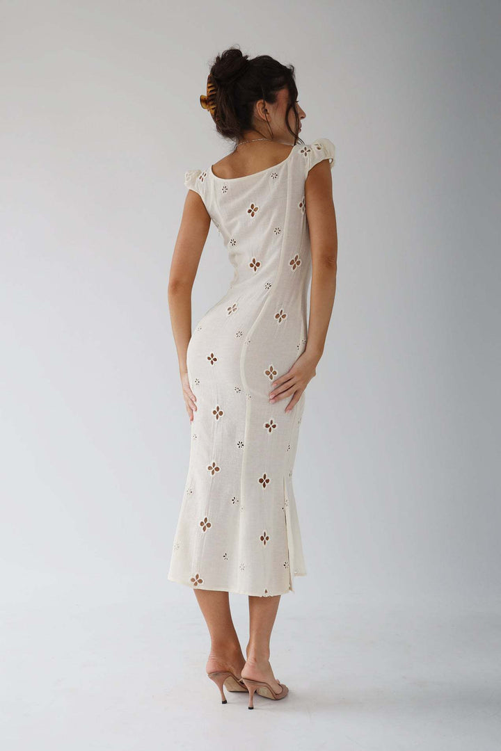 Full-length view of a women's elegant embroidered mermaid wedding dress.