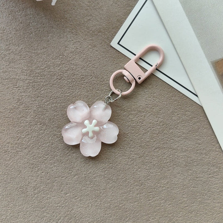 Delicate floral keychain charm with bright petals & metal accents for women's bags.