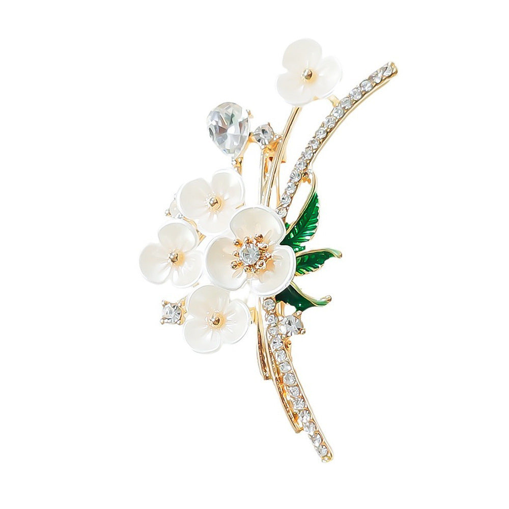 Delicate floral rhinestone brooch, ideal as a dress pin or elegant accessory for coats and scarves.