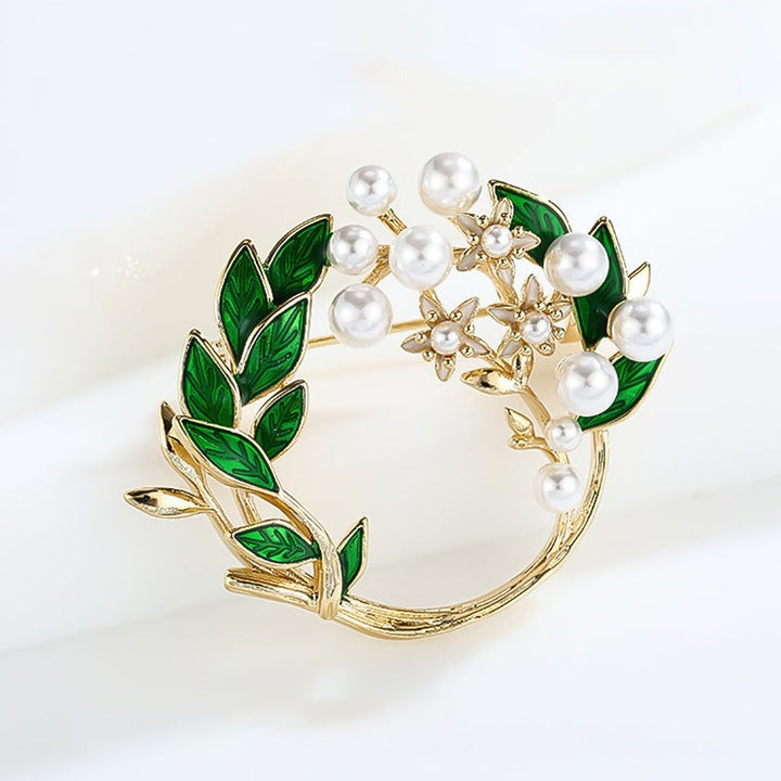 Close-up of an elegant floral rhinestone brooch, highlighting intricate pearl detailing and sparkle.
