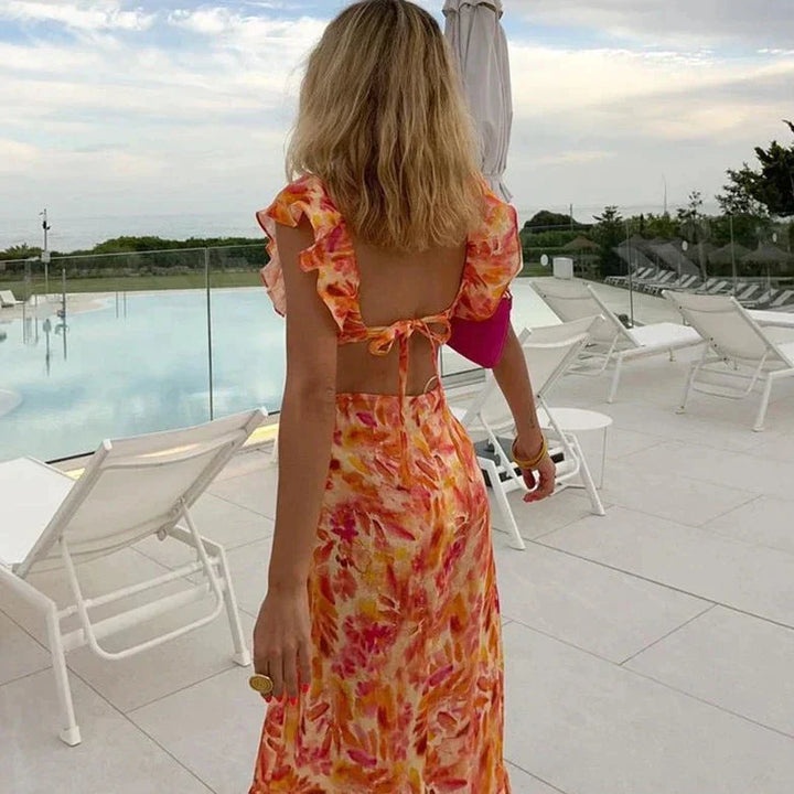 Feminine floral print maxi dress for women, featuring elegant ruffles & a long, flowy design for spring/summer.