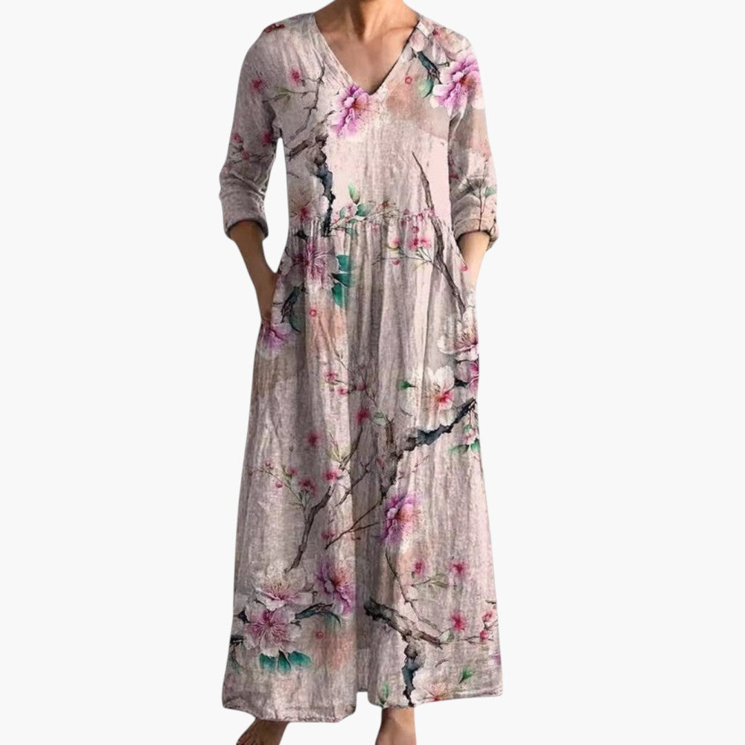 Women's flowy V-neck maxi dress with a vibrant floral pattern, ideal for beach or casual wear.