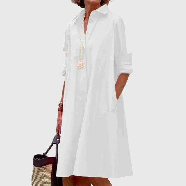 Woman wearing a flowy, elegant women's dress with pockets. Perfect for comfortable casual everyday style.