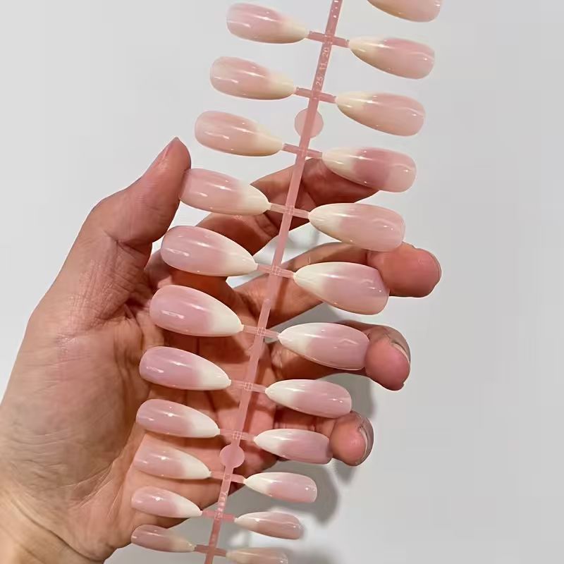 Sophisticated French tip press-on acrylic nails. Elegant nude false nails for women, perfect for any special occasion.