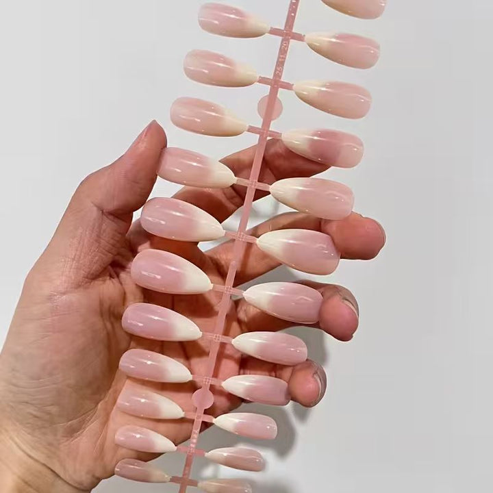 Sophisticated French tip press-on acrylic nails. Elegant nude false nails for women, perfect for any special occasion.