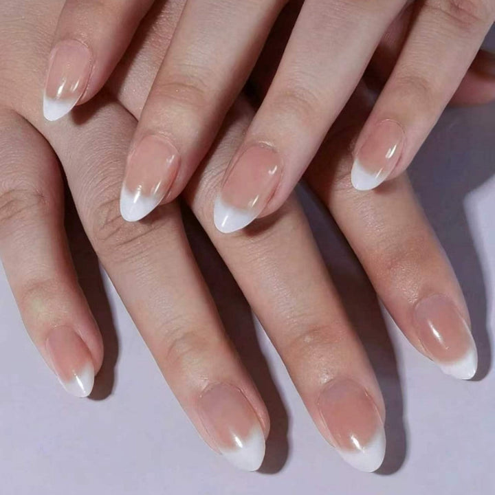Elegant French tip press-on nail art kit for women, perfect for a salon-quality at-home manicure with clear & nude tips.