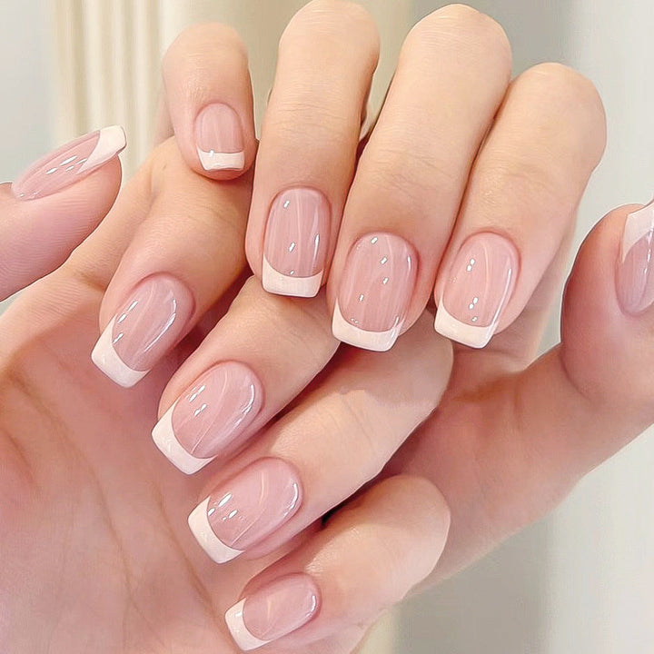 Elegant French tip press-on nail set for women. Reusable artificial nails for a classic salon-quality manicure.