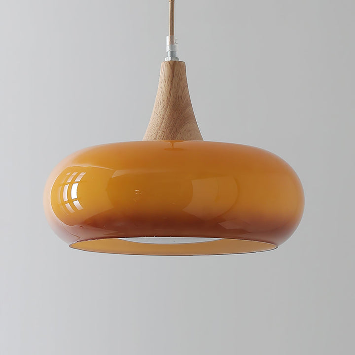 Modern ceiling pendant light: glass, wood, metal for dining room. Stylish and functional.