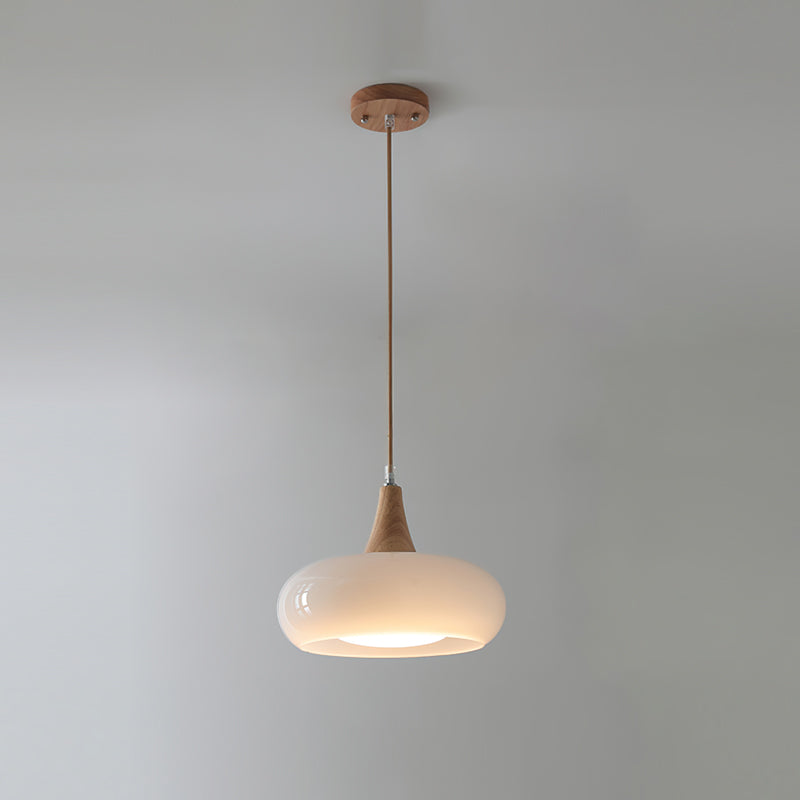 Stylish glass and wood pendant light for a sleek kitchen design. Modern and functional.
