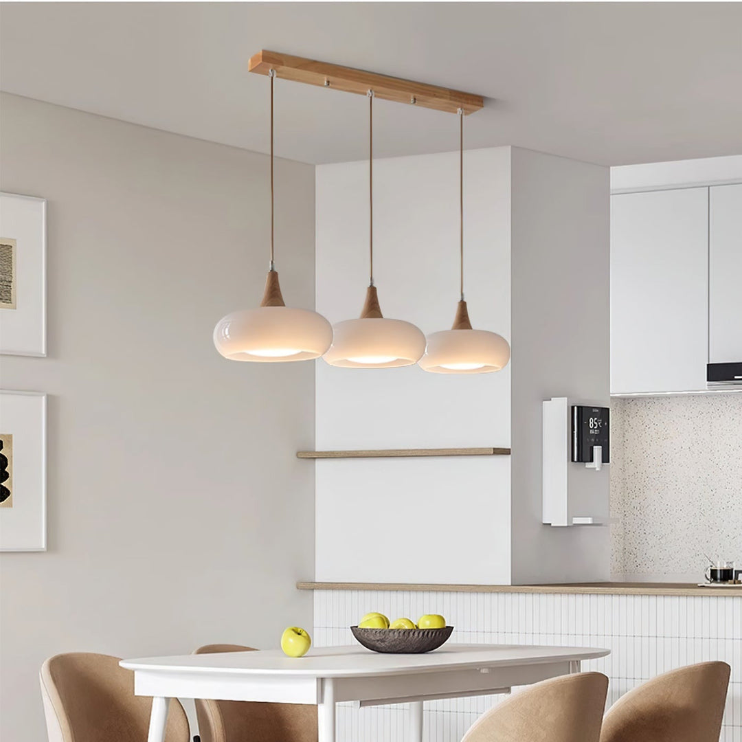 Decorative glass, wood, metal pendant light, enhancing modern home decor. Chic ceiling fixture.