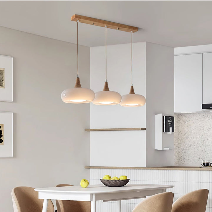 Decorative glass, wood, metal pendant light, enhancing modern home decor. Chic ceiling fixture.