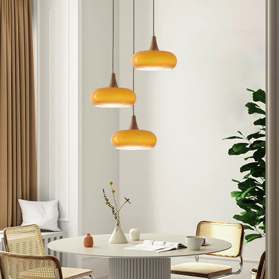 Chic glass and wood ceiling light fixture for modern interiors. Provides warm ambient lighting.