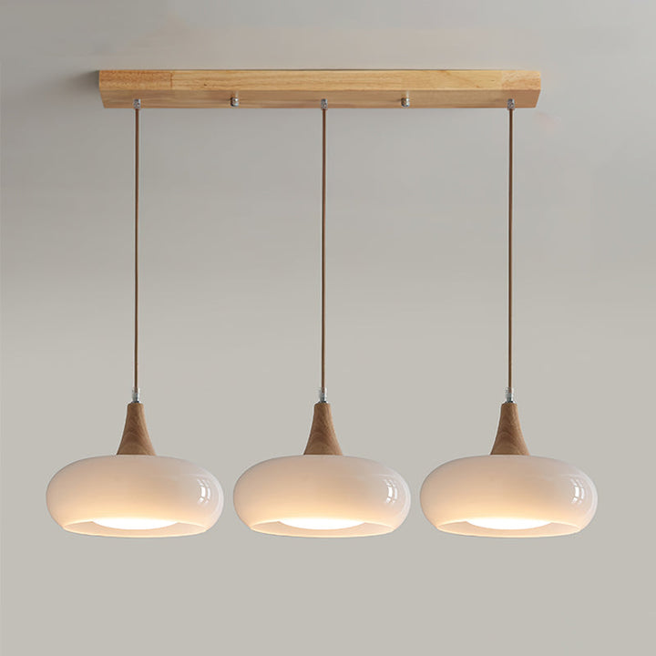 Elegant pendant light featuring a clear glass shade and natural wood detail. Modern design.