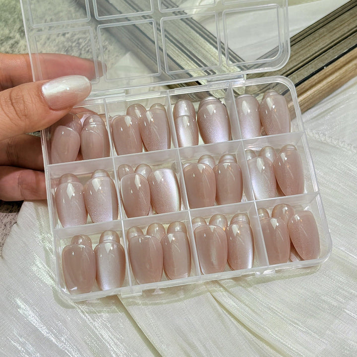 Close-up of glossy press-on nails, highlighting the smooth, reflective finish. Perfect elegant women's manicure.