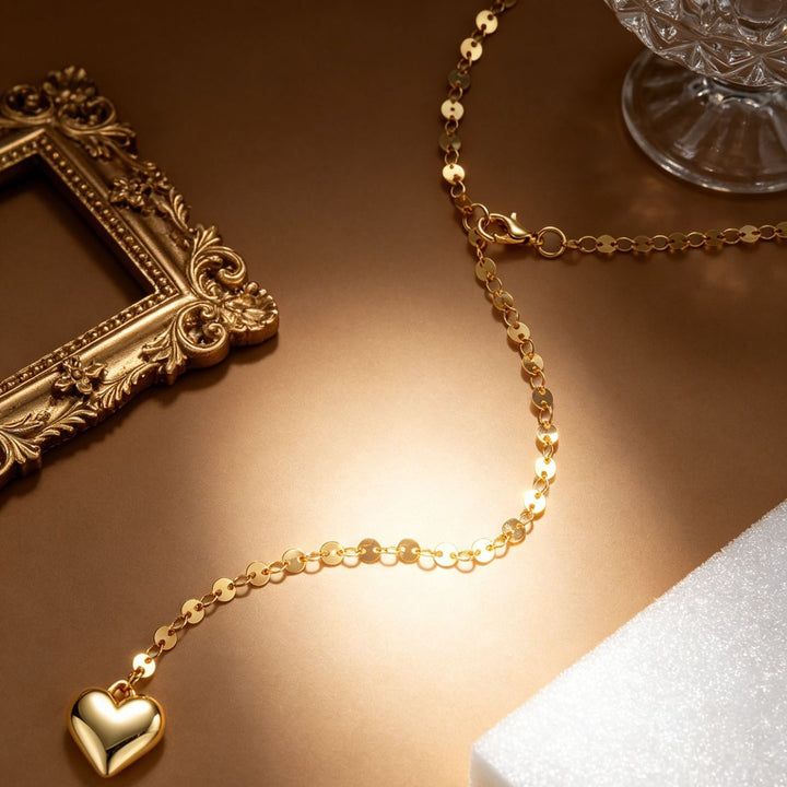 Delicate gold body chain with heart pendant for women, an elegant piece of beach and festival jewelry.